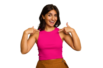 Young Indian woman isolated on green chroma background surprised pointing with finger, smiling broadly.
