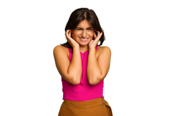 Young Indian woman isolated on green chroma background covering ears with hands.