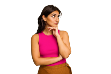 Young Indian woman isolated on green chroma background contemplating, planning a strategy, thinking about the way of a business.