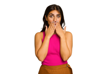 Young Indian woman isolated on green chroma background shocked, covering mouth with hands, anxious to discover something new.
