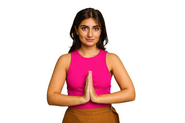 Young Indian woman isolated on green chroma background praying, showing devotion, religious person...