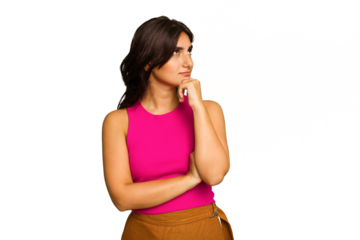 Young Indian woman isolated on green chroma background thinking and looking up, being reflective, contemplating, having a fantasy.