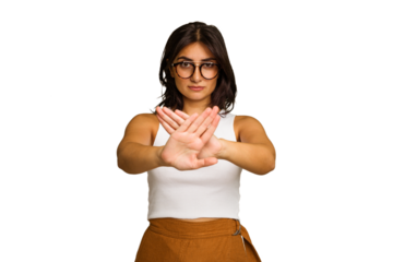 Young Indian woman isolated on green chroma background standing with outstretched hand showing stop sign, preventing you.