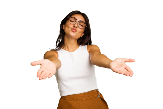 Young Indian woman isolated on green chroma background folding lips and holding palms to send air kiss.