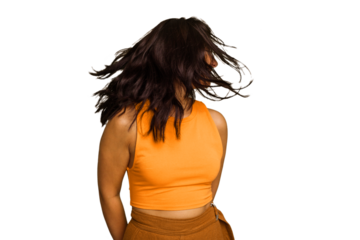 Young Indian woman isolated on green chroma background dancing and having fun.