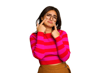 Young Indian woman isolated on green chroma background crying, unhappy with something, agony and confusion concept.