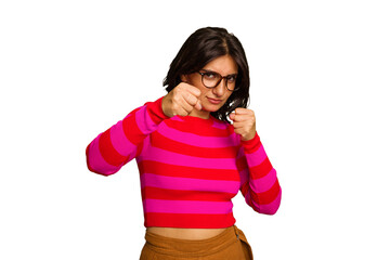 Young Indian woman isolated on green chroma background throwing a punch, anger, fighting due to an argument, boxing.