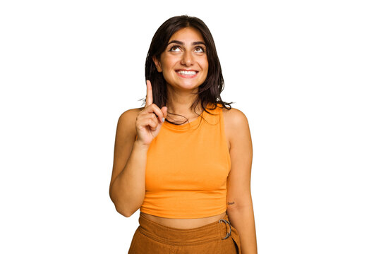 Young Indian woman isolated on green chroma background indicates with both fore fingers up showing a blank space.