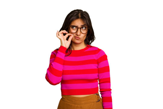 Young Indian woman isolated on green chroma background with fingers on lips keeping a secret.