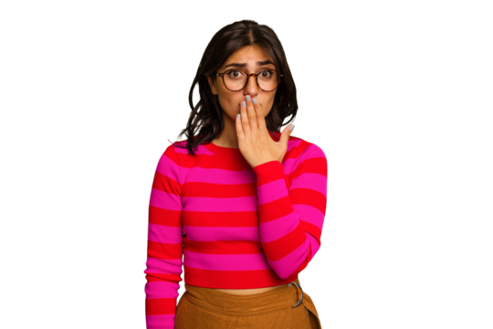 Young Indian woman isolated on green chroma background shocked, covering mouth with hands, anxious to discover something new.
