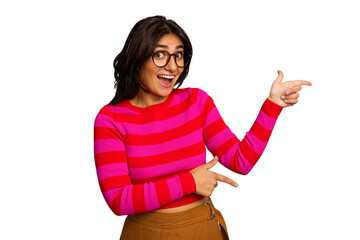 Young Indian woman isolated on green chroma background excited pointing with forefingers away.