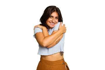 Young Indian woman isolated on green chroma background hugs, smiling carefree and happy.