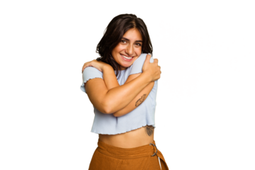 Young Indian woman isolated on green chroma background hugs, smiling carefree and happy.