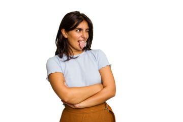 Young Indian woman isolated on green chroma background funny and friendly sticking out tongue.