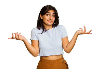 Young Indian woman isolated on green chroma background doubting and shrugging shoulders in questioning gesture.