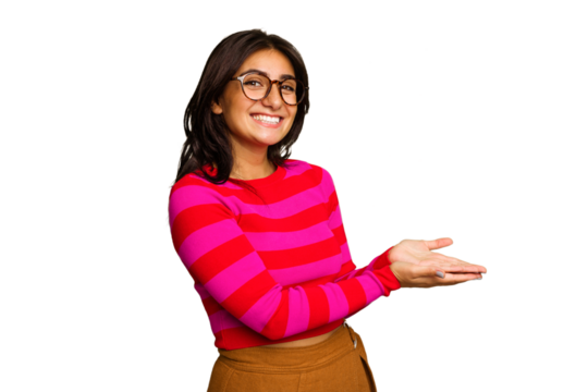Young Indian woman isolated on green chroma background holding a copy space on a palm.