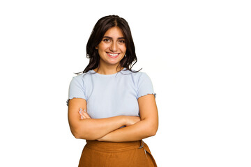 Young Indian woman isolated on green chroma background who feels confident, crossing arms with determination.