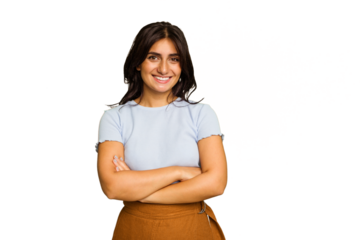 Young Indian woman isolated on green chroma background who feels confident, crossing arms with determination.