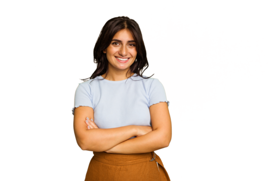 Young Indian woman isolated on green chroma background who feels confident, crossing arms with determination.