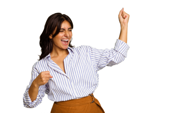 Young Indian woman isolated on green chroma background cheering carefree and excited. Victory concept.