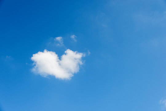 Heart shaped cloud against blue sky
