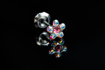 Jewelry with stone earrings, luxury silver earrings with diamonds, sapphires on a black background.