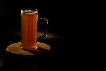  Мug of beer isolated with light in the background.Space for text