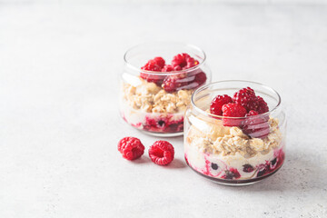 Overnight oatmeal with raspberries, currants and tahini in jar. Breakfast concept.