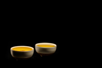 Obraz na płótnie Canvas Traditional japanese, chinese asian tea ceremony concept. White ceramic tea cups with lotus on black background. Copy space. 