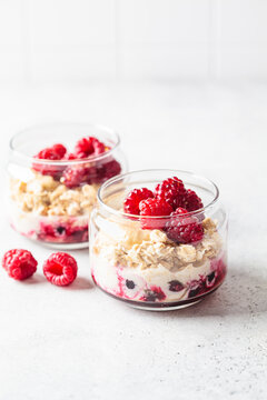 Overnight oatmeal with raspberries, currants and tahini in jar. Breakfast concept.