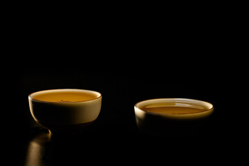 Two cups of chinese tea  with steam isolated on black background. Top view