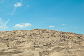 Fototapeta na wymiar sand and blue sky, in the photo sand mountain blue sky and clouds