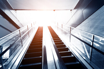 Escalator in business center leading to light