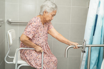 Asian senior or elderly old lady woman patient use toilet bathroom handle security in nursing...