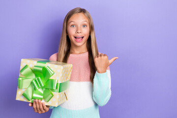 Photo of overjoyed girl hand hold package arm direct show empty space offer service preparing event isolated on purple color background