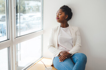 African-american young woman waiting someone who late, in coffee shop. Woman drink coffee. Stress...
