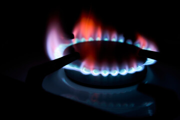 Kitchen gas burner, close-up. Burning gas