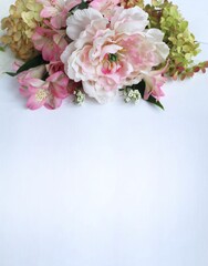 Bouquet of pink roses, peonies and alstroemeria on a white background. Festive flower arrangement. Background for a greeting card.