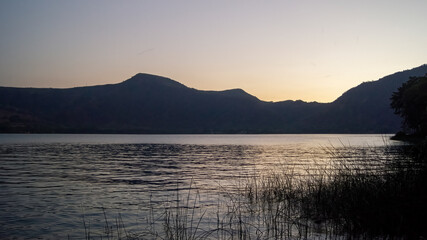 lake of chapala, jalisco mexico, lake at sunset with fishing boats, sun reflection on the lake, mexico
