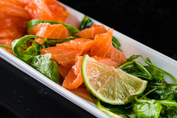 salmon sashimi with lime and arugula