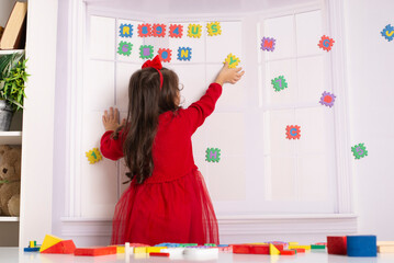 Portrait of a 4-year-old girl. Child learns letters and numbers