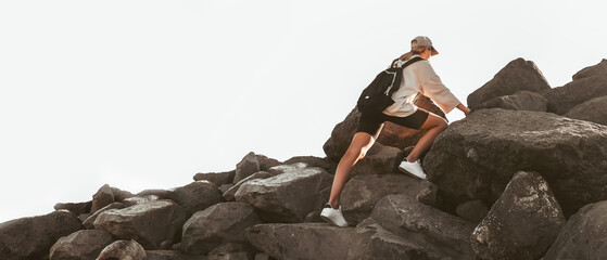 Traveler on a peak with a high mountain .Young woman rock climbing on a cliff.Success,achievement concept.Travel eco