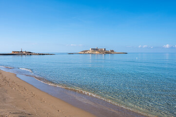 Fototapeta na wymiar The beautiful Beach of Correnti with transparent and blue water in Portopalo in Sicily