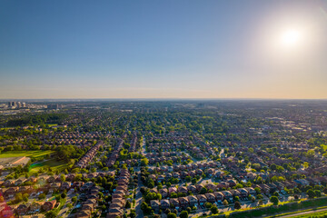 Aerial view of rich American citizen’s suburb at golden hour summertime. Established Real estate...
