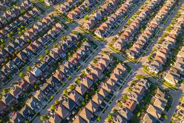 Aerial view of middle class residential houses at summer evening. American neighbourhood suburb....
