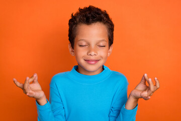 Photo portrait of cute little pupil boy closed eyes meditate peaceful mind relax wear trendy blue...