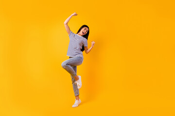 Fototapeta na wymiar Full body photo of delighted cheerful person raise fists attainment triumph empty space isolated on yellow color background
