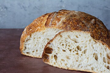 Fresh homemade sourdough bread with whole grain flour on a on a gray-brown background. Healthy food.
