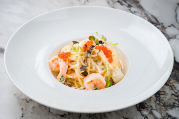 Italian pasta fettuccine in a creamy sauce with shrimp