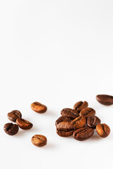 Scattered  roasted coffee beans  on white isolated background